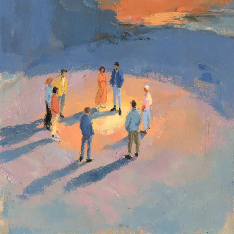 A group of people standing together in a circle at golden hour
